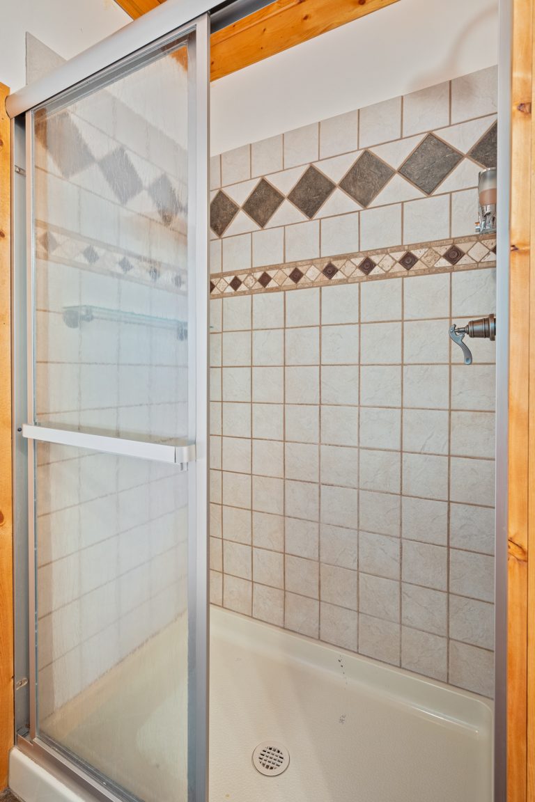 Tiled walk-in shower House in Reed City, Michigan — Lakeside Lodge Retreat, hosted by Roam