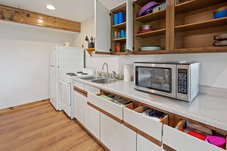 Kitchen with wood cabinetry House in Reed City, Michigan — Lakeside Lodge Retreat, hosted by Roam