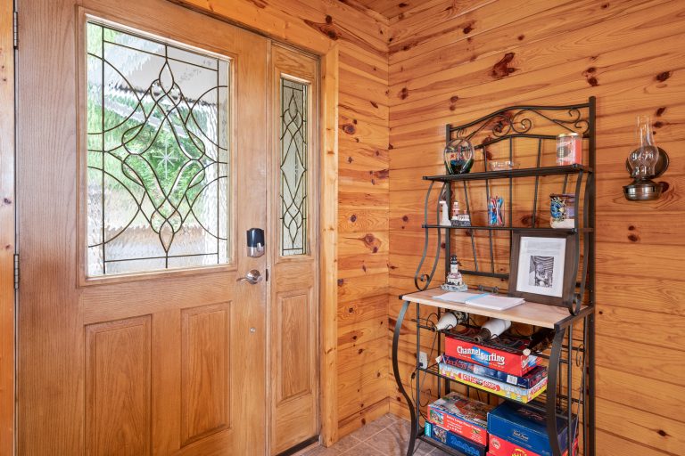 Entryway with glass-paneled door and shelving in Reed City, Michigan house — Lakeside Lodge Retreat, hosted by Roam
