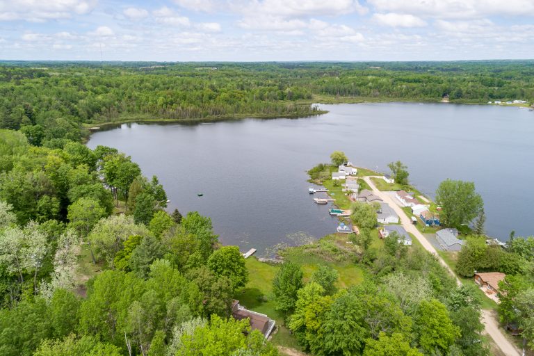 Aerial view of the lake near the property House in Reed City, Michigan — Lakeside Lodge Retreat, hosted by Roam
