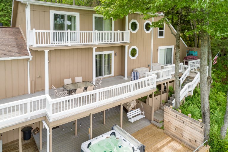 Multi-level deck with hot tub House in Reed City, Michigan — Lakeside Lodge Retreat, hosted by Roam