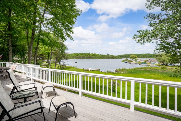 Deck lounge chairs with lake view House in Reed City, Michigan — Lakeside Lodge Retreat, hosted by Roam
