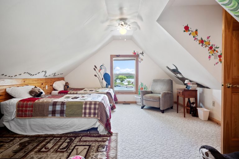 Attic bedroom with lake-view window House in Reed City, Michigan — Lakeside Lodge Retreat, hosted by Roam