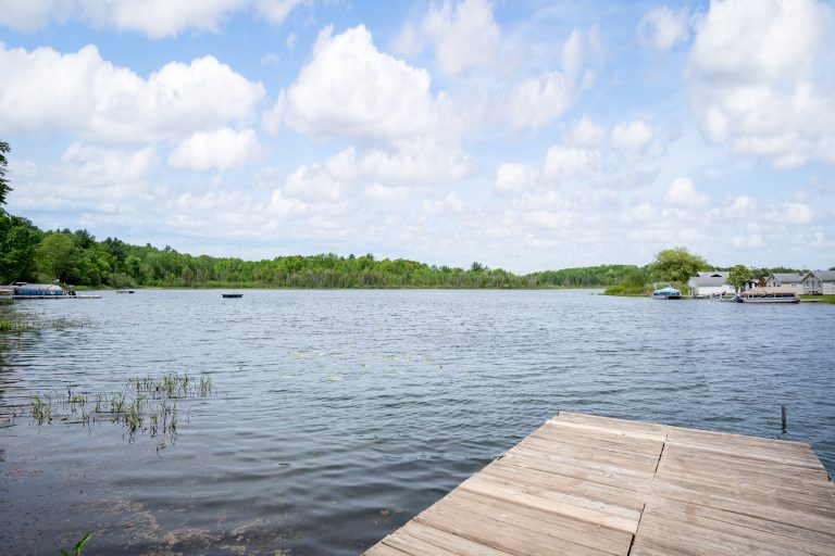 Private dock on the lake House in Reed City, Michigan — Lakeside Lodge Retreat, hosted by Roam