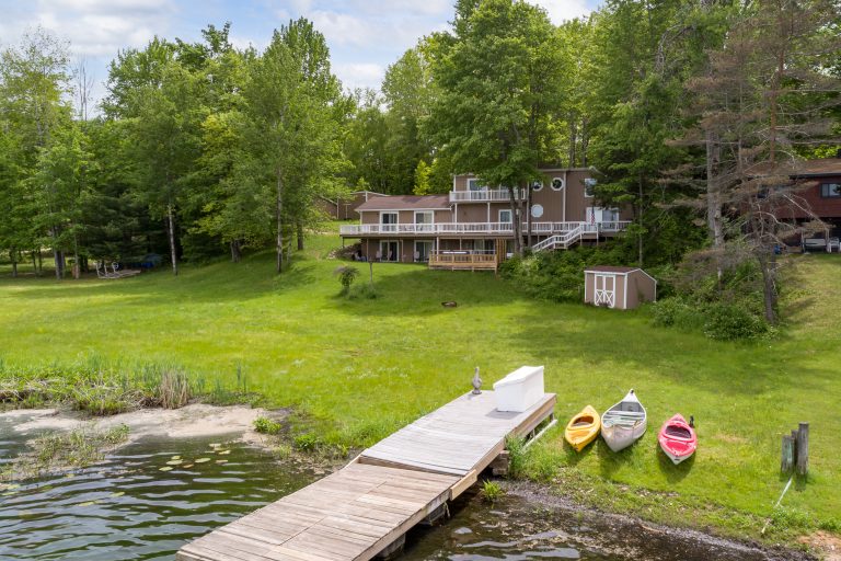 Lakefront House in Reed City, Michigan with dock and kayaks — Lakeside Lodge Retreat, hosted by Roam