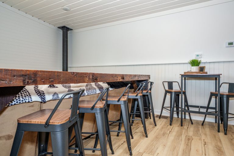 Bar seating with reclaimed wood counter Cabin in Mecosta, Michigan — Silent Waters Retreat, hosted by Roam