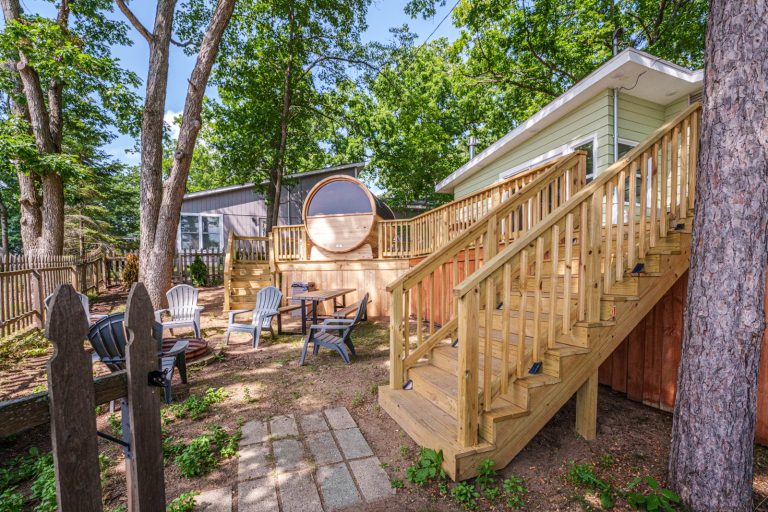 Backyard sauna and patio seating Cabin in Mecosta, Michigan — Silent Waters Retreat, hosted by Roam