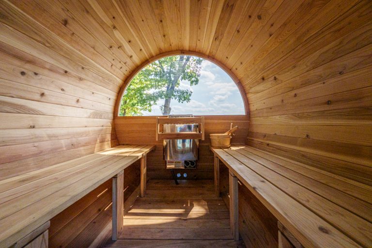 Barrel sauna interior with wood benches in this Mecosta, Michigan cabin — Silent Waters Retreat, hosted by Roam