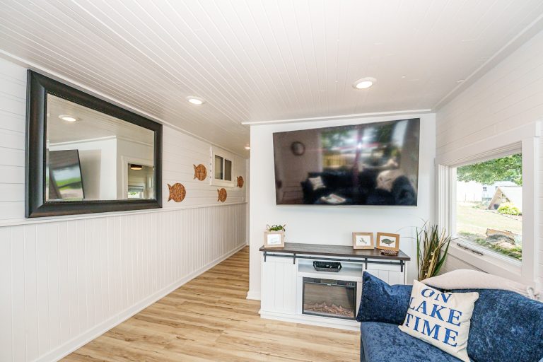 Hallway with mirror and wall art near the living room in this Mecosta, Michigan cabin — Silent Waters Retreat, hosted by Roam