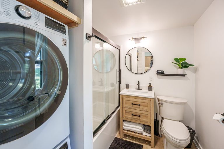 Bathroom with stacked laundry Cabin in Mecosta, Michigan — Silent Waters Retreat, hosted by Roam