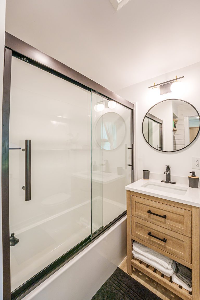 Bathroom with glass shower and vanity Cabin in Mecosta, Michigan — Silent Waters Retreat, hosted by Roam