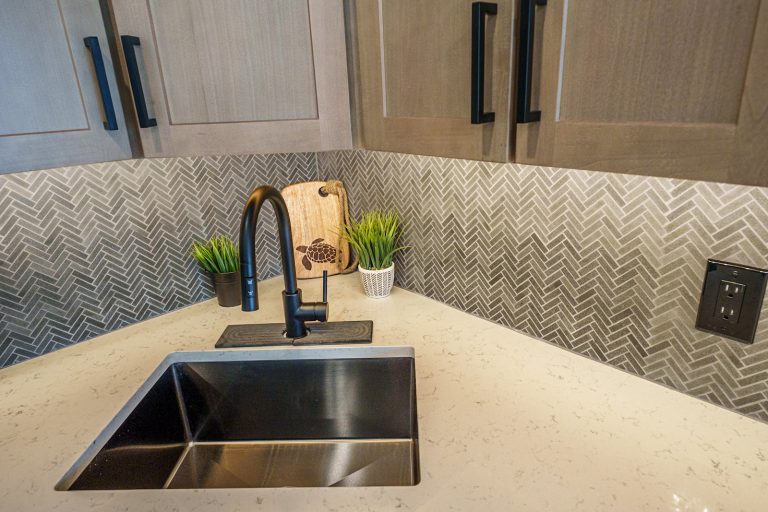 Kitchen sink with herringbone tile Cabin in Mecosta, Michigan — Silent Waters Retreat, hosted by Roam