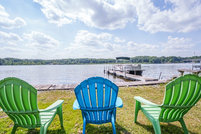 Lakeside Adirondack chairs and dock Cabin in Mecosta, Michigan — Silent Waters Retreat, hosted by Roam