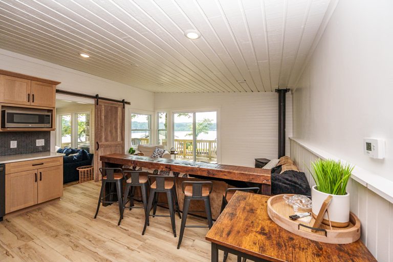 Open kitchen and dining with lake view Cabin in Mecosta, Michigan — Silent Waters Retreat, hosted by Roam