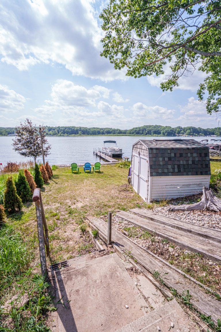 Backyard with dock and lake view Cabin in Mecosta, Michigan — Silent Waters Retreat, hosted by Roam