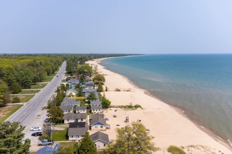 Aerial view of beach road and cottages Cabin in Oscoda, Michigan — Barefoot Beach Cabin #4, hosted by Roam