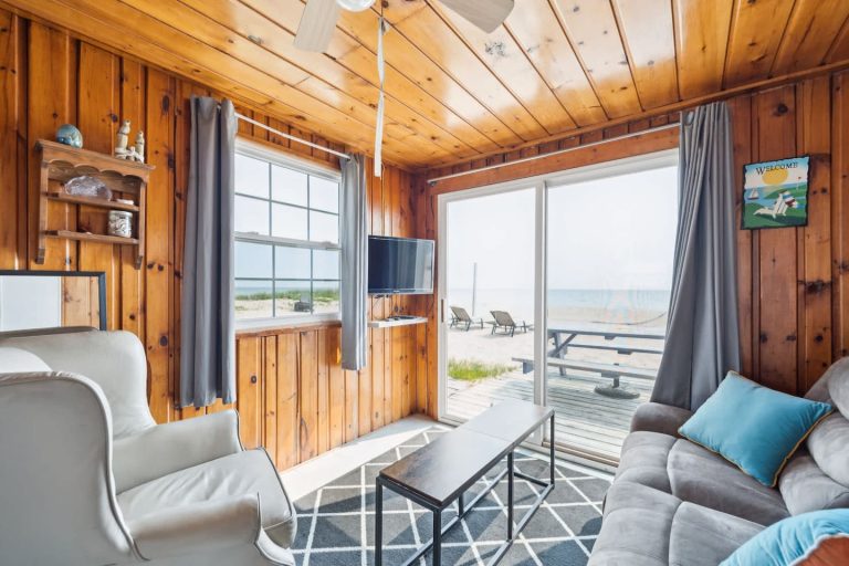 Living room with beach-facing sliding door Cabin in Oscoda, Michigan — Barefoot Beach Cabin #4, hosted by Roam