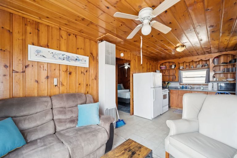 Living area open to the kitchen Cabin in Oscoda, Michigan — Barefoot Beach Cabin #4, hosted by Roam