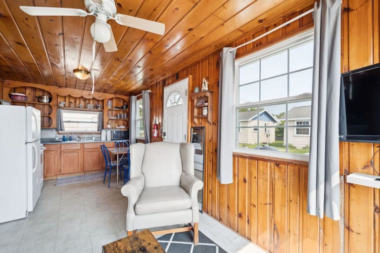 Living area with kitchen and dining space Cabin in Oscoda, Michigan — Barefoot Beach Cabin #4, hosted by Roam