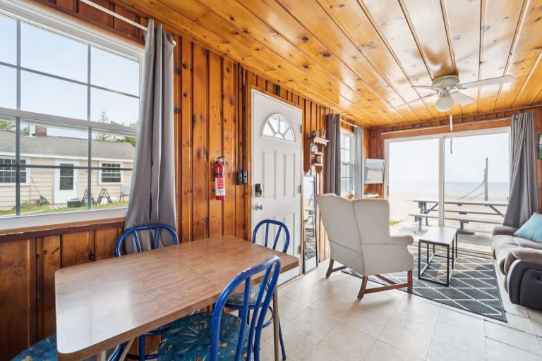 Dining area with view toward the beach Cabin in Oscoda, Michigan — Barefoot Beach Cabin #4, hosted by Roam