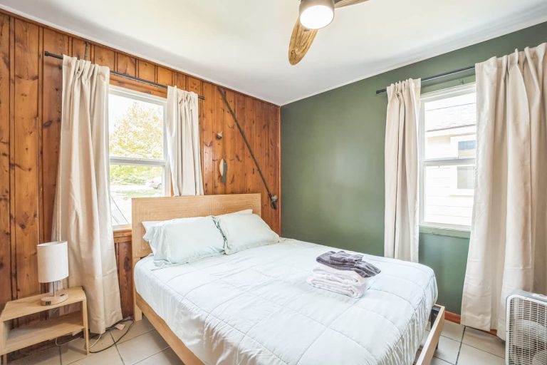 Green-accent bedroom Cabin in Oscoda, Michigan — Barefoot Beach Cabin #5, hosted by Roam