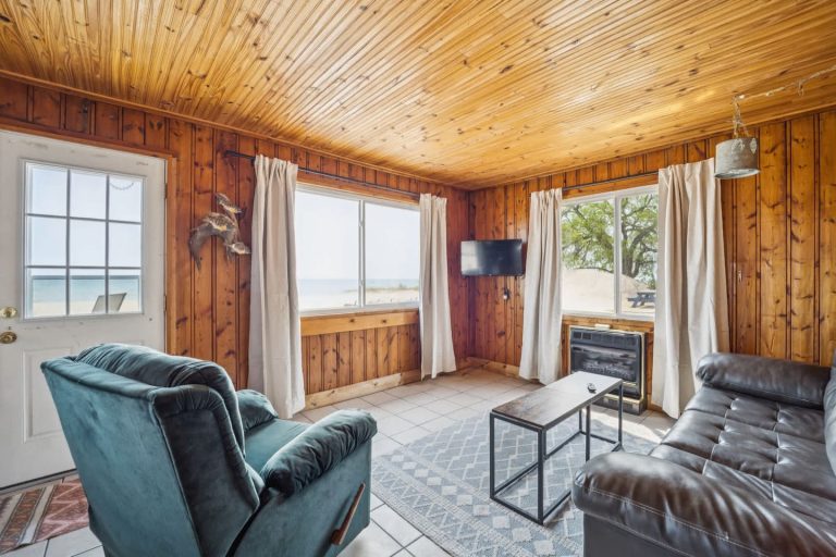 Living room with lake view Cabin in Oscoda, Michigan — Barefoot Beach Cabin #5, hosted by Roam