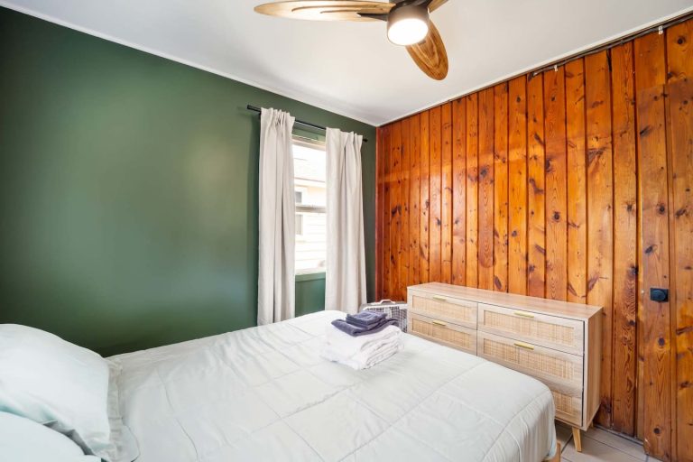 Green-walled bedroom Cabin in Oscoda, Michigan — Barefoot Beach Cabin #5, hosted by Roam