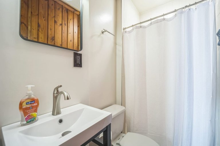 Bathroom with vanity and shower Cabin in Oscoda, Michigan — Barefoot Beach Cabin #6, hosted by Roam
