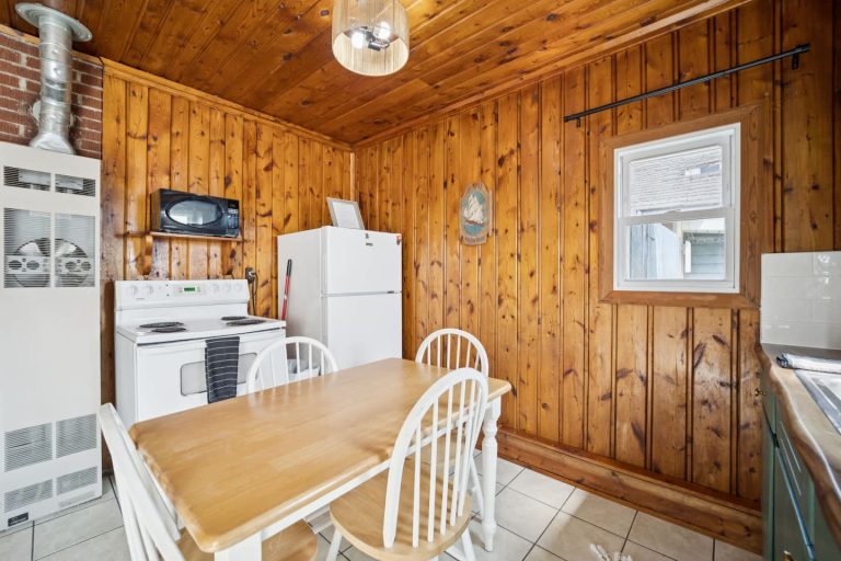 Kitchen with wood dining table Cabin in Oscoda, Michigan — Barefoot Beach Cabin #6, hosted by Roam