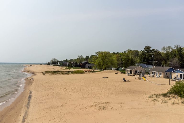 Wide sandy beach with playground Cabin in Oscoda, Michigan — Barefoot Beach Cabin #6, hosted by Roam