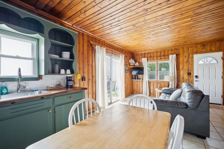 Kitchen and dining area, green cabinets Cabin in Oscoda, Michigan — Barefoot Beach Cabin #6, hosted by Roam