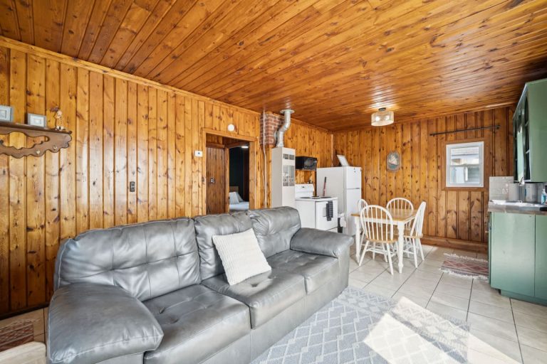 Open living room and kitchen Cabin in Oscoda, Michigan — Barefoot Beach Cabin #6, hosted by Roam