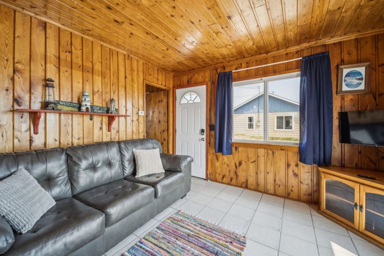 Living room with leather sofa Cabin in Oscoda, Michigan — Barefoot Beach Cabin #7, hosted by Roam