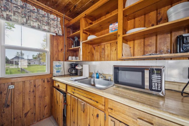 Kitchen shelving and sink Cabin in Oscoda, Michigan — Barefoot Beach Cabin #7, hosted by Roam