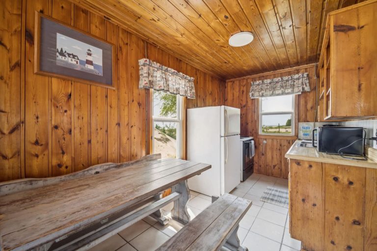 Dining nook with picnic table Cabin in Oscoda, Michigan — Barefoot Beach Cabin #7, hosted by Roam