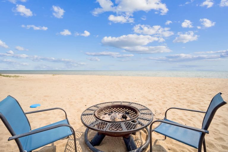 Beachside fire pit and chairs Cabin in Oscoda, Michigan — Barefoot Beach Cabin #7, hosted by Roam